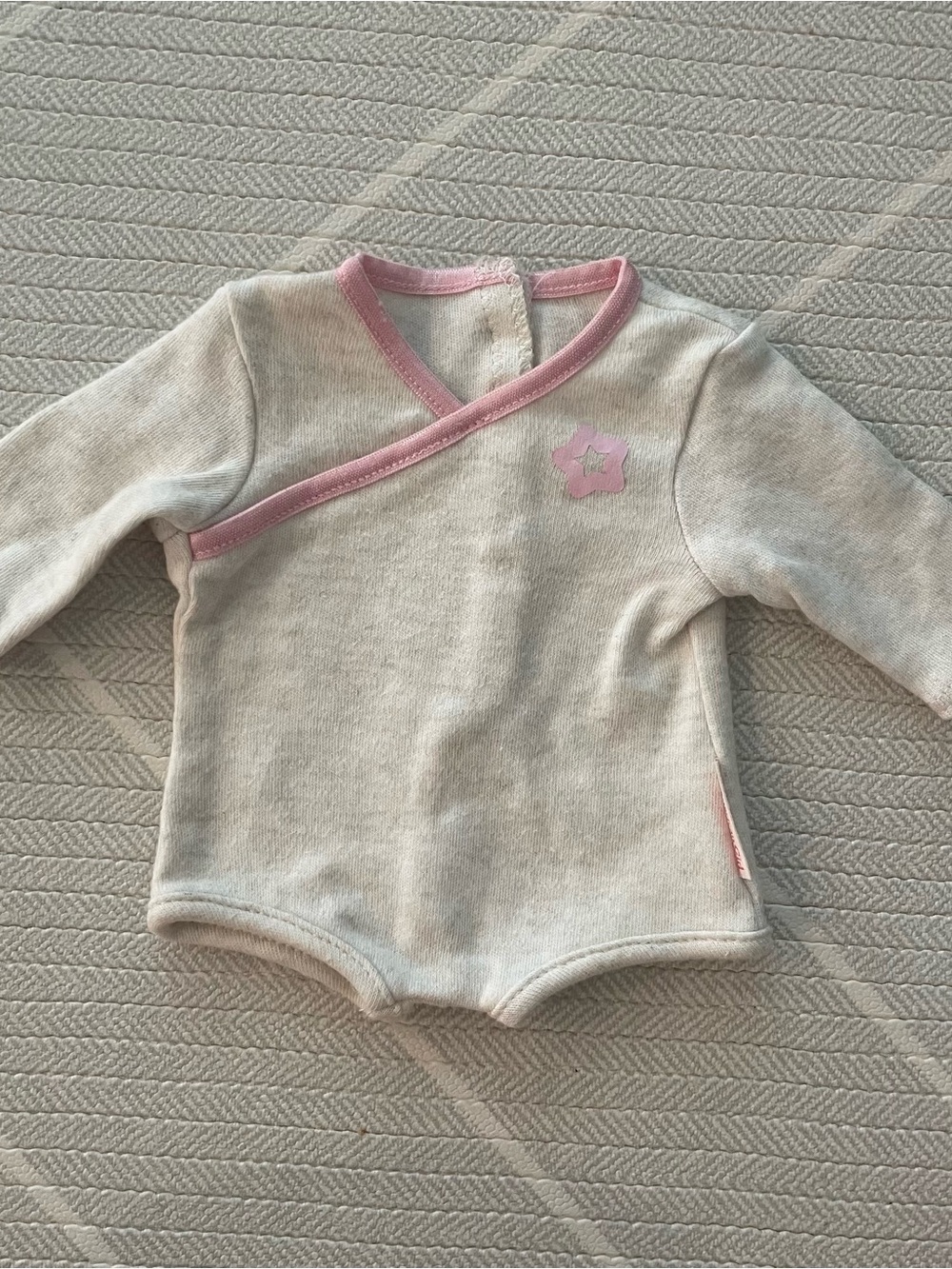 American Girl Bitty Baby bodysuit with pink satin binding and a star Print